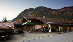 a house with a car parked in front of it at Chalet Edelweiß in Pfronten