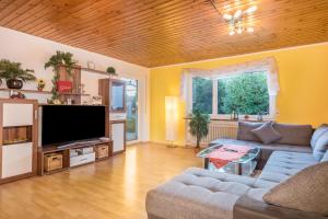 a living room with a couch and a flat screen tv at Ferienwohnung Sonnenschein in Langenargen