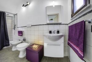 a bathroom with a sink and a toilet and a mirror at Arricàmpati Airport Home & Bringo Car Rental in Carini