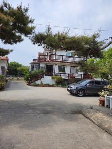 a car parked in front of a house at Ganghwa Sweet House Pension in Incheon