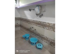 a bathroom with two blue stools and a mirror at Rann Chandni Resort, Kutch, Bhuj in Bherandiāla