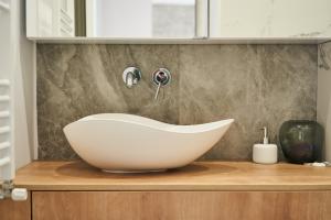 a bathroom with a white bath tub on a counter at Ultracentral two rooms apartment in Bucharest in Bucharest