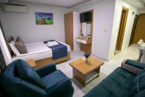 a living room with a bed and two couches at Güven House İstanbul in Istanbul
