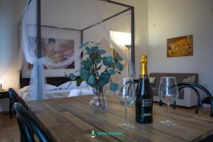 a table with a bottle of champagne and two wine glasses at Ostia Holiday Naxos in Lido di Ostia