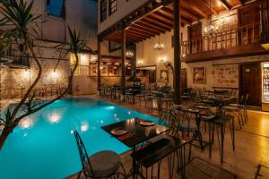 - une piscine avec des tables et des chaises dans un restaurant dans l'établissement Mediterra Art Hotel Antalya, à Antalya