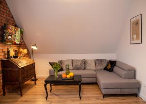 a living room with a couch and a table at Dluga 66 Attic in Gdańsk