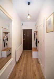 a hallway with a door and a wooden floor at Dluga 66 Attic in Gdańsk