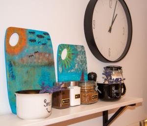a shelf with a clock and other items on it at Dluga 66 Attic in Gdańsk