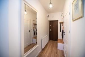 a hallway with a large mirror and a closet at Dluga 66 Attic in Gdańsk