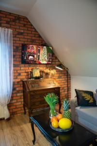 a living room with a table with fruit on it at Dluga 66 Attic in Gdańsk