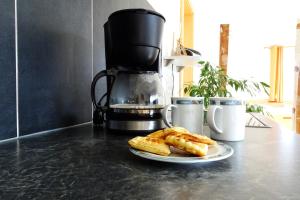 a plate of bread on a counter with a coffee maker at Apartment Mountain View in Fliess +19 photos