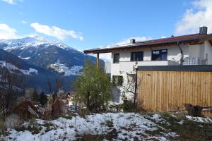 una casa en las montañas con nieve en el suelo en Apartment Mountain View, en Fliess