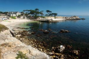 a view of a beach with rocks and the ocean at Ramada by Wyndham Marina in Marina