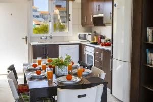 a kitchen with a table with oranges on it at Green Bay Penthouse 2 in Protaras