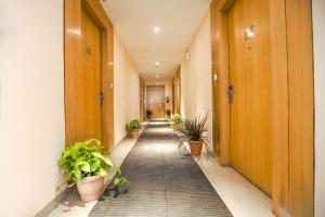 an empty hallway with potted plants in an office building at The Stories Hotel in Ludhiana
