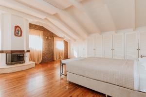 a bedroom with a bed and a television in it at Unique Thasos Beach Villa in Prinos