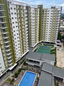 an aerial view of a apartment complex with a tennis court at Mesaverte Deluxe Studio with Balcony in Cagayan de Oro