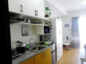 a kitchen with a sink and a counter top at Mesaverte Deluxe Studio with Balcony in Cagayan de Oro