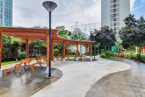 a pavilion in a park with benches and a street light at MOIRA by Kozystay 2BR Great Location & Bathtub in Jakarta