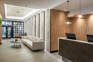 a living room with a couch and a table at Hotel Don Jaime 54 in Zaragoza