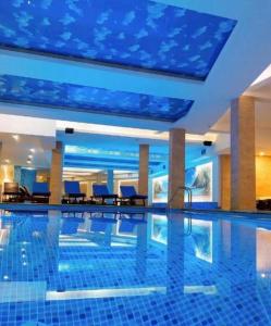 a swimming pool in a hotel with a blue ceiling at Vuk apartment - Milmari Resort & Spa in Kopaonik