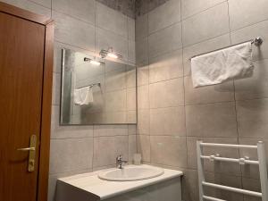 a bathroom with a sink and a mirror at Rivendell Apartments Flora Complex in Borovets +46 photos