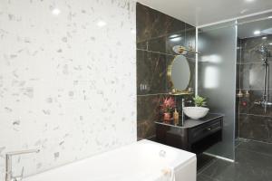 a bathroom with a white tub and a mirror at Dolce Mia Home Ninh Bình in Ninh Binh +60 photos