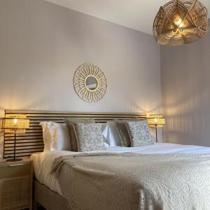 a bedroom with a large bed and a mirror on the wall at Bailgate Barn, Ashlin Farm Barns in Lincoln