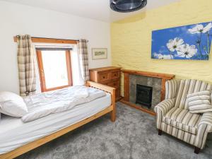 a bedroom with a bed and a fireplace at Nant Moel Isaf Farm in Swansea
