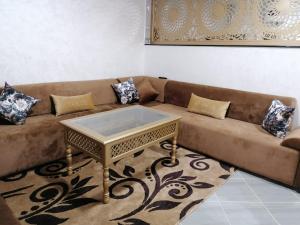 a couch with a coffee table in a living room at Appartement lux dakhla in Dakhla