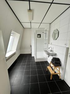 La salle de bains est pourvue d'un lavabo, de toilettes et d'un miroir. dans l'établissement Hotel de Raket, à Rogat