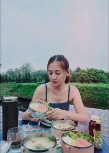 a woman sitting at a table with a cake at เขาเจ้าขา2 in Khao Kho