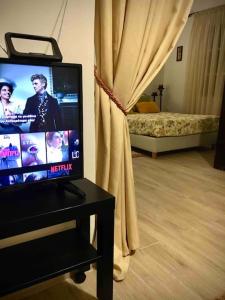 A television and/or entertainment centre at Cozy house with backyard at Iraklio Attikis