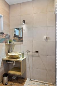 a bathroom with a sink and a shower at Pensiunea Podul Simonului in Bran +78 photos