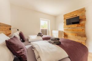 a bedroom with two beds and a flat screen tv at Reitstieg in Braunlage