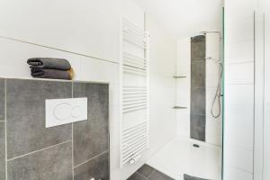 a bathroom with white walls and a shower with a glass door at Reitstieg in Braunlage +16 photos