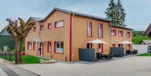 a large wooden house with tables and chairs in front of it at Reitstieg in Braunlage