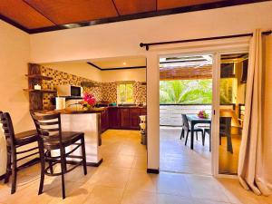 a kitchen and dining room with a table and chairs at Seaside Self Catering in Mahe