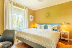 a bedroom with a large bed and a window at Hyggeglück Braunlage in Braunlage