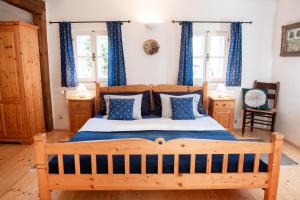 a bedroom with a wooden bed with blue curtains at Chalupa nad Popelkou in Lomnice nad Popelkou