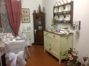 a room with a dresser and a table and a chair at Cisanello House in Pisa