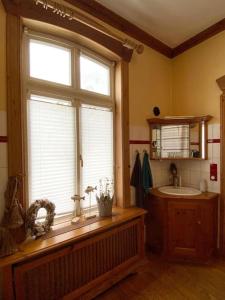 a bathroom with a large window and a sink at Ahoi Husum, anlegen und wohlfühlen in Husum