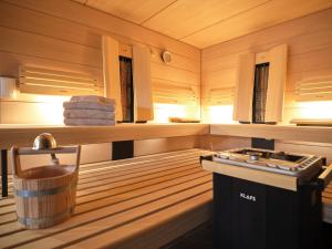 a sauna with a tub and a sink in it at HILL - 73 by AA Holiday Homes in Tauplitz