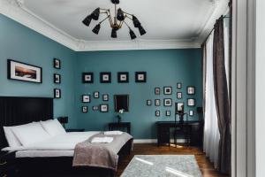 a bedroom with a bed and a blue wall at Sherlock Apartments in Riga