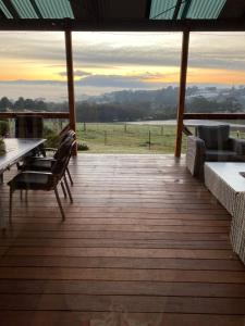 a wooden deck with a view of a field at The Residence - Yarra Valley in Wandin North