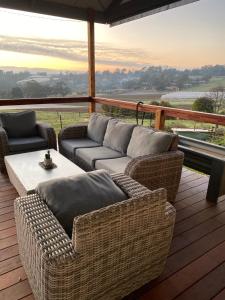 a patio with couches and a table on a deck at The Residence - Yarra Valley in Wandin North