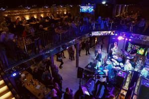 an overhead view of a crowd of people at a bar at night at Hotel Mölndals Bro in Mölndal