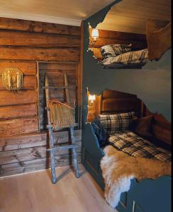 a bedroom with a bed in a log cabin at Traditional timber farm with Sauna & Wi-Fi in Baukål +10 photos