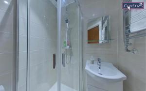 a bathroom with a shower and a sink at Victoria House - Deluxe Studios in Coventry City Centre, free parking, by COVSTAYS in Coventry +175 photos