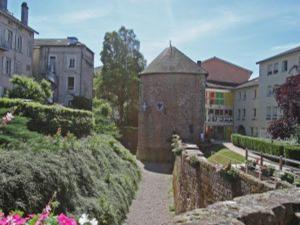 a walkway leading to a building with a tower at Appartement Rénové, Proche Centre-Ville Épinal, 2 Chambres, Confort, WiFi, Parking - FR-1-589-54 in Épinal